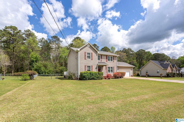 colonial home featuring a front yard, driveway, fence, and an attached garage