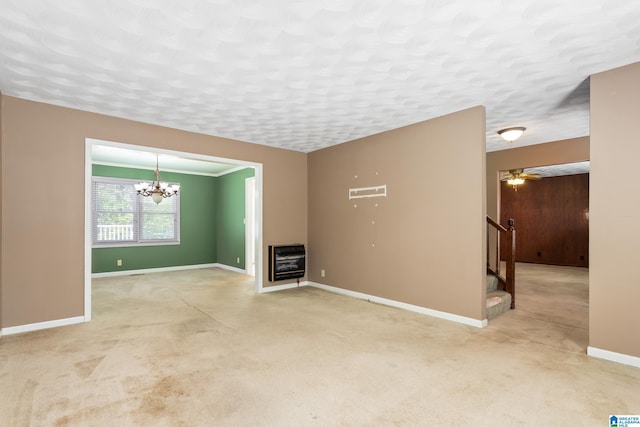 unfurnished living room featuring carpet flooring, baseboards, heating unit, and stairs