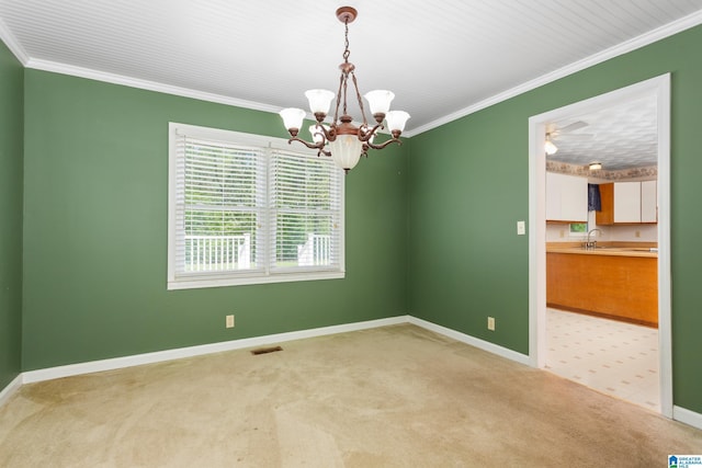 carpeted spare room featuring crown molding, an inviting chandelier, baseboards, and visible vents