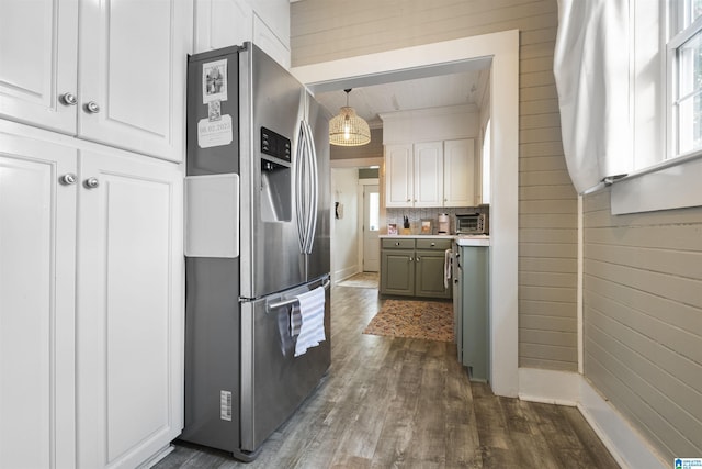 kitchen featuring stainless steel fridge with ice dispenser, tasteful backsplash, light countertops, white cabinets, and dark wood finished floors