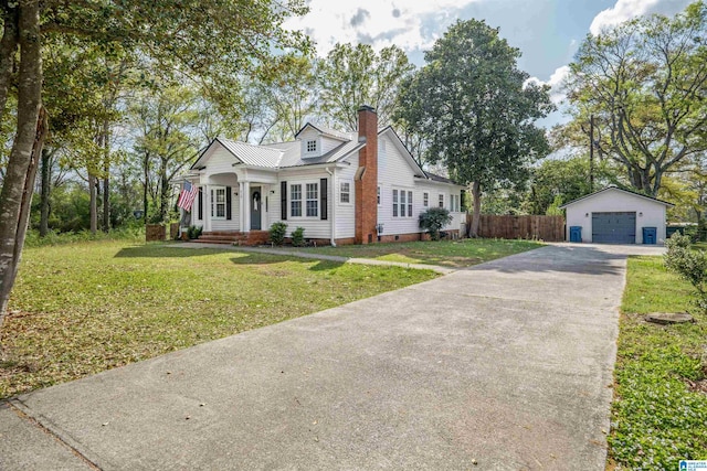 view of front of house featuring a detached garage, crawl space, fence, an outdoor structure, and a front lawn