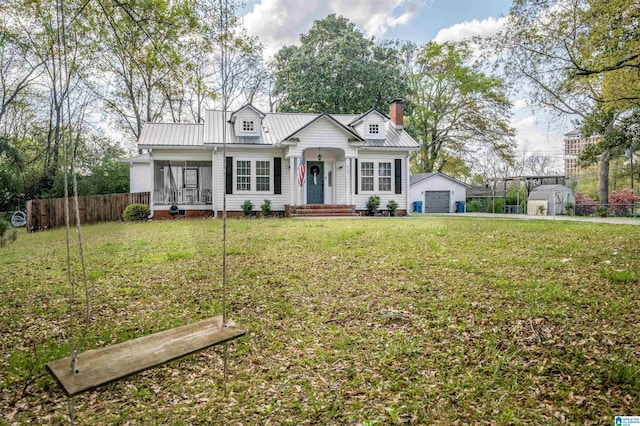 view of front facade with an outdoor structure, fence, a front lawn, a chimney, and a garage