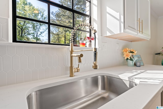 details with white cabinets and light stone countertops