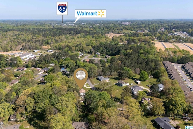 birds eye view of property with a view of trees