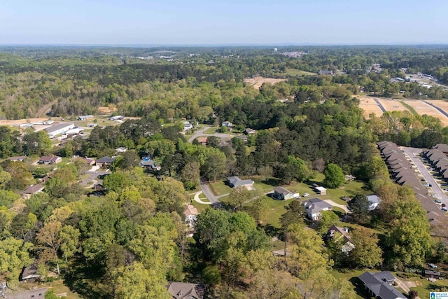 bird's eye view with a wooded view