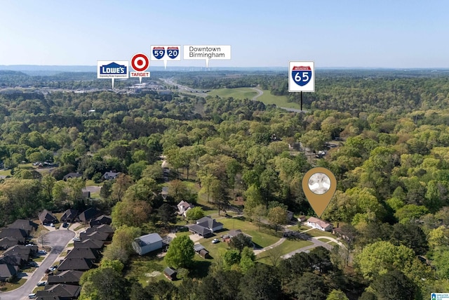 birds eye view of property with a wooded view