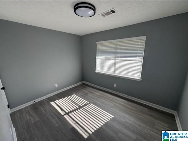 438 Henry St, Birmingham, AL 35214 - spare room featuring visible vents, baseboards, wood finished floors, and a textured ceiling