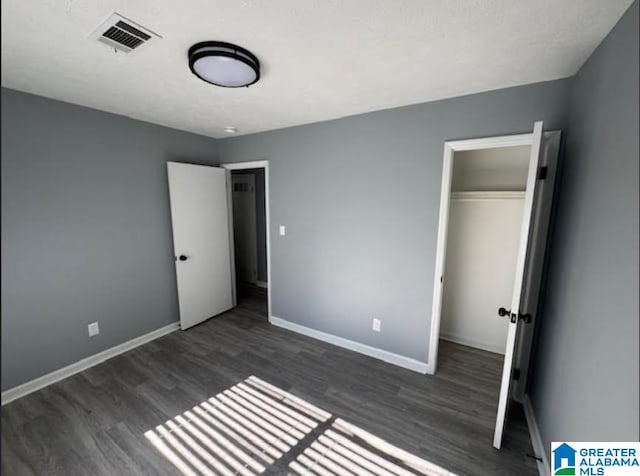 438 Henry St, Birmingham, AL 35214 - unfurnished bedroom featuring visible vents, baseboards, a closet, and wood finished floors