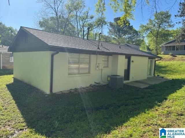 438 Henry St, Birmingham, AL 35214 - exterior space with central air condition unit, roof with shingles, stucco siding, and a lawn