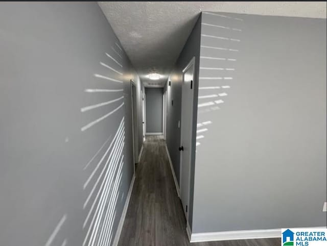 438 Henry St, Birmingham, AL 35214 - corridor featuring dark wood-style flooring, baseboards, and a textured ceiling