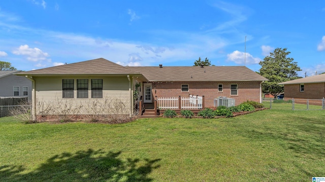 rear view of house featuring a yard, a fenced backyard, a wooden deck, and central AC