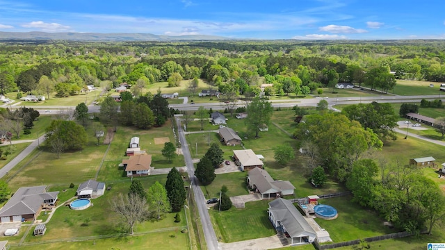 birds eye view of property with a forest view