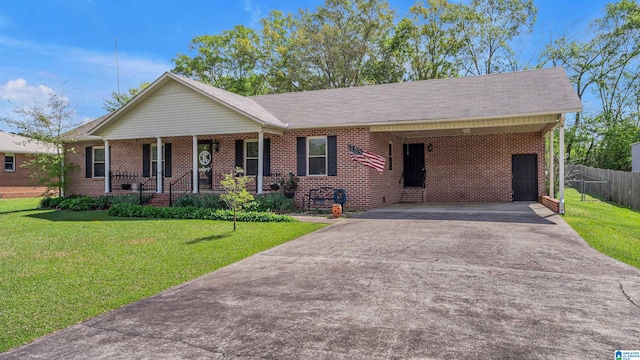ranch-style home featuring a porch, fence, a front lawn, brick siding, and driveway