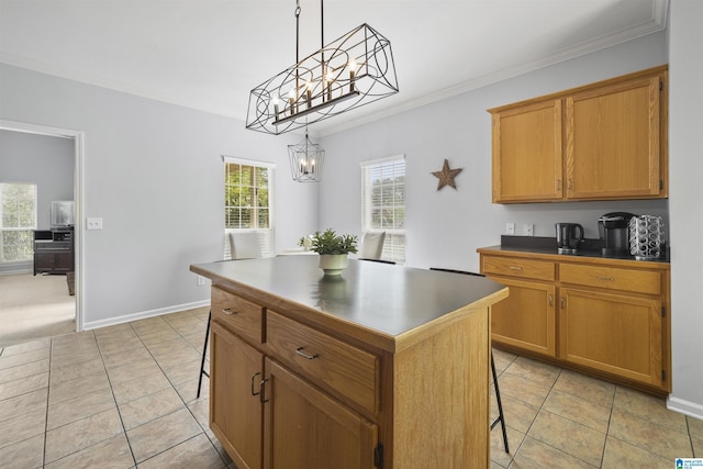 kitchen featuring dark countertops, a kitchen island, a breakfast bar area, and a notable chandelier