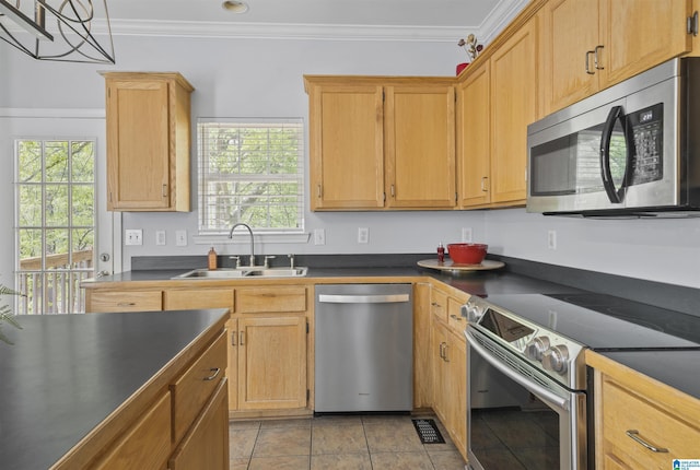 kitchen with crown molding, dark countertops, visible vents, stainless steel appliances, and a sink