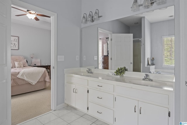 ensuite bathroom featuring double vanity, ceiling fan, a sink, and ensuite bath