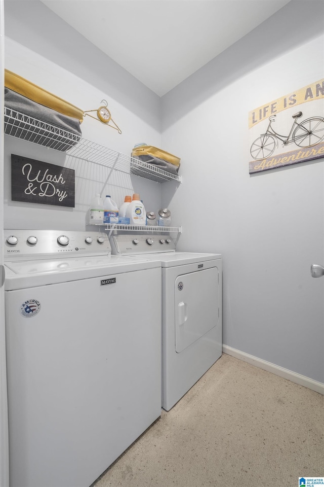 laundry room featuring washing machine and clothes dryer, laundry area, and baseboards