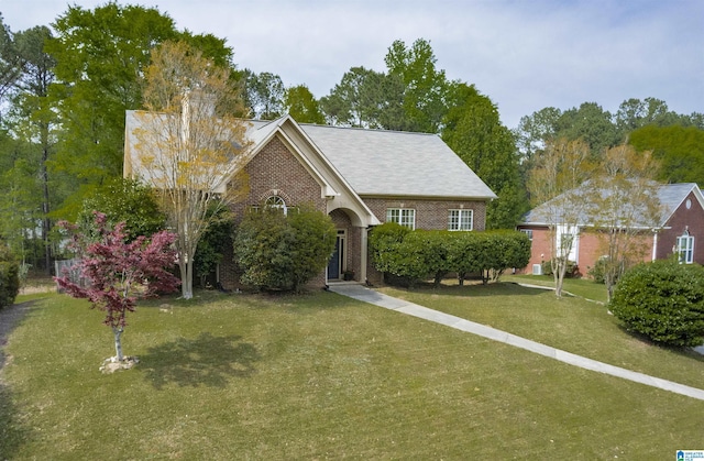 view of front facade featuring a front lawn and brick siding