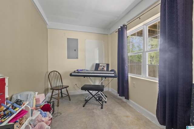 living area with concrete flooring, baseboards, and electric panel