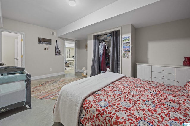 bedroom featuring a closet, baseboards, and visible vents