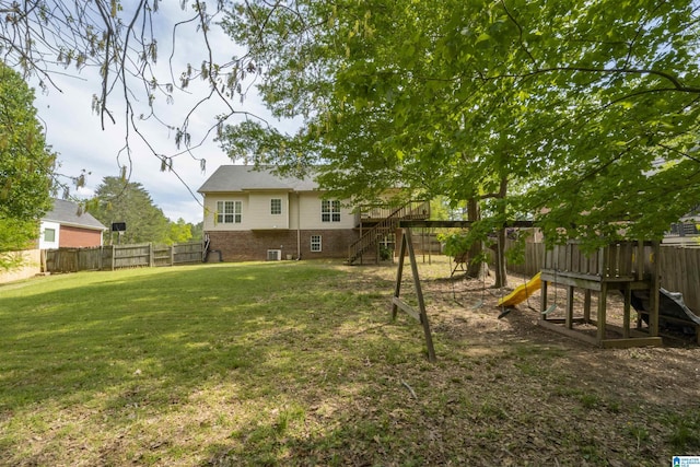 view of yard featuring a fenced backyard and a playground
