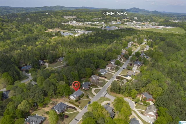 birds eye view of property with a forest view and a residential view