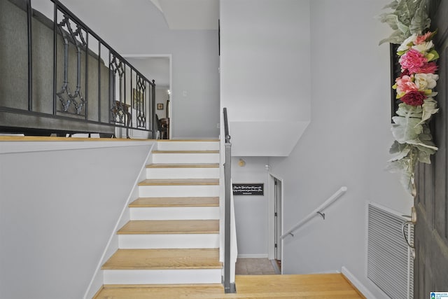 stairs with visible vents and baseboards