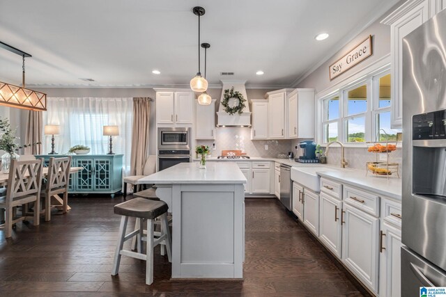 6037 Clubhouse Dr, Trussville, AL 35173 - kitchen with stainless steel appliances, dark wood-style flooring, white cabinets, ornamental molding, and recessed lighting