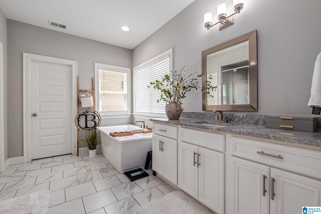 6037 Clubhouse Dr, Trussville, AL 35173 - bathroom with vanity, marble look tile flooring, a freestanding bath, a shower stall, and recessed lighting