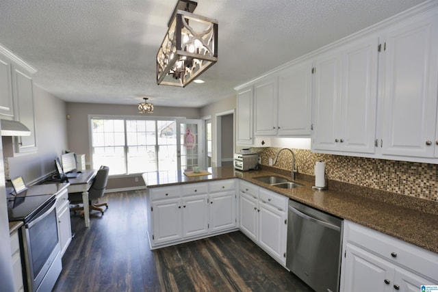 kitchen featuring dark wood finished floors, a textured ceiling, a chandelier, appliances with stainless steel finishes, and a sink