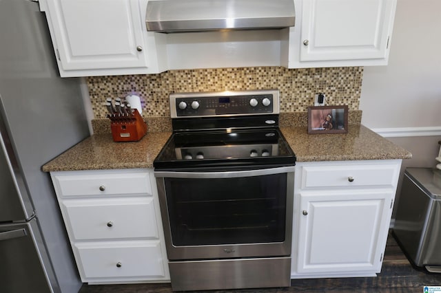 kitchen featuring stainless steel appliances, wall chimney exhaust hood, white cabinetry, and decorative backsplash