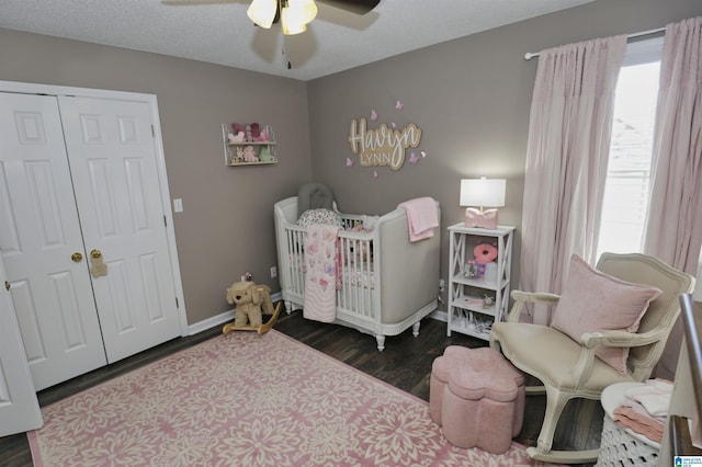 bedroom featuring ceiling fan, a closet, baseboards, and wood finished floors