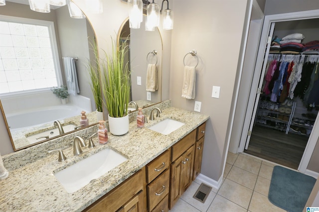 bathroom featuring tile patterned floors, double vanity, visible vents, and a sink