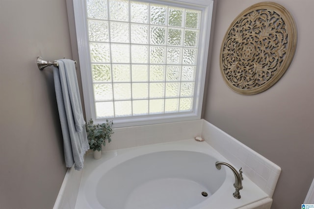 bathroom with a bath and a healthy amount of sunlight