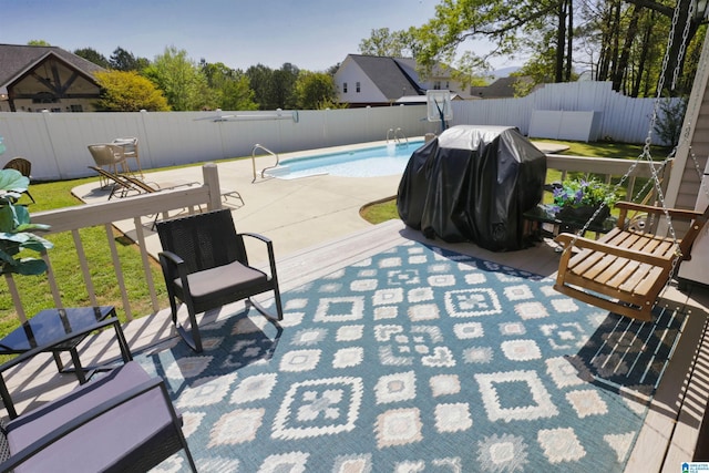 view of swimming pool featuring a fenced backyard, a grill, a fenced in pool, and a patio