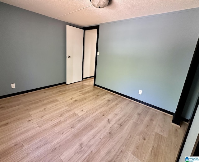 empty room featuring light wood-style floors and baseboards