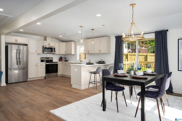 1121 Lawley St, Helena, AL 35080 - dining space with a notable chandelier, plenty of natural light, vaulted ceiling, and light wood-style floors