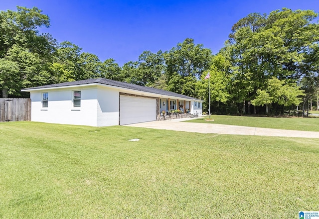 view of front of property featuring a garage, driveway, fence, and a front lawn