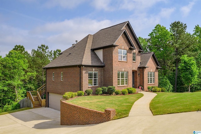 view of front of property featuring brick siding, a shingled roof, stairs, and concrete driveway