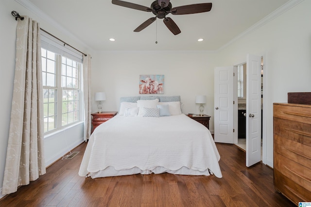 bedroom with dark wood-type flooring, ornamental molding, and multiple windows