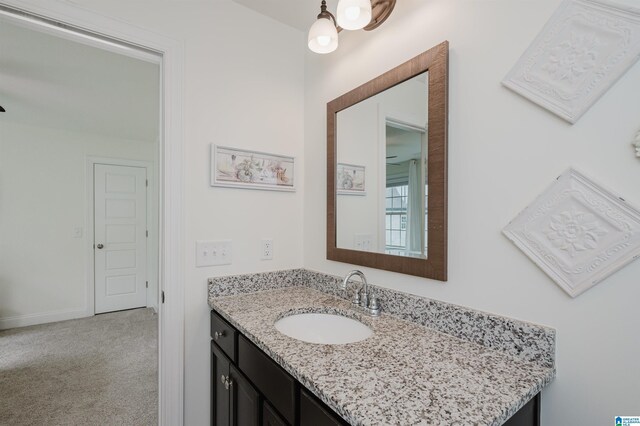 bathroom featuring baseboards and vanity