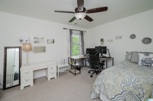 bedroom featuring light colored carpet, ceiling fan, and visible vents