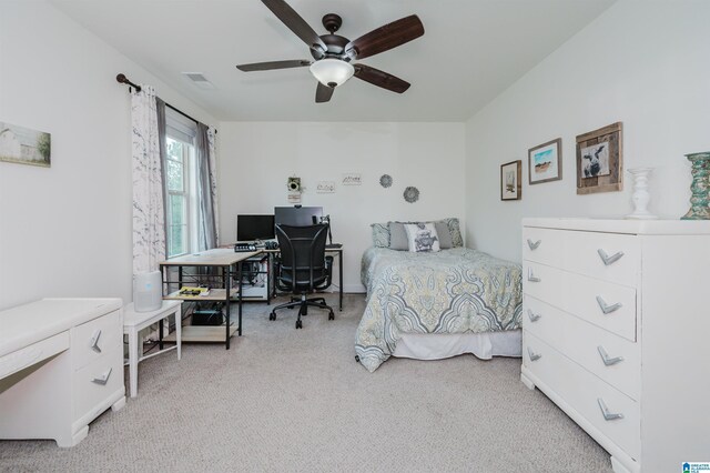 bedroom featuring light carpet, a ceiling fan, and visible vents