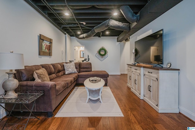 living area featuring dark wood-type flooring and baseboards