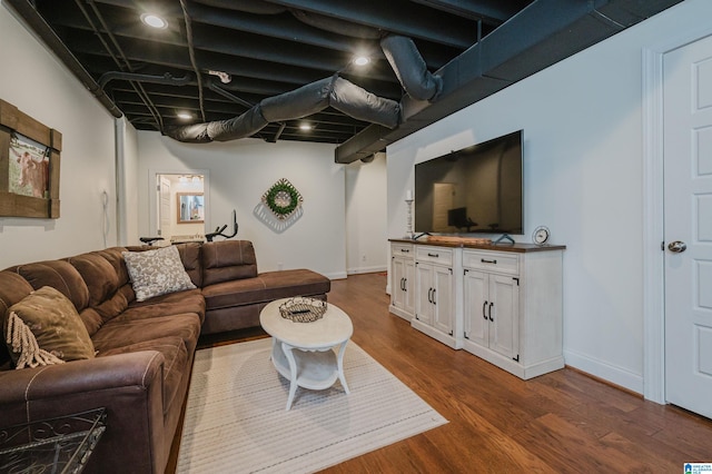 living room featuring baseboards and dark wood-style floors
