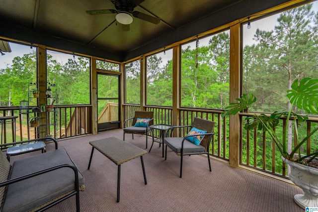 sunroom featuring a ceiling fan