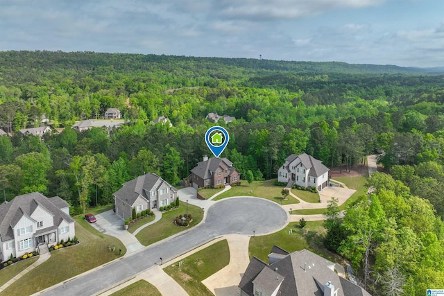 bird's eye view featuring a residential view and a wooded view