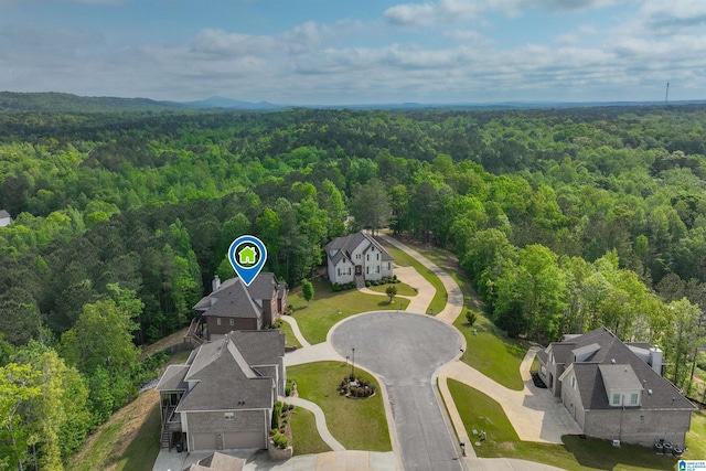birds eye view of property with a wooded view