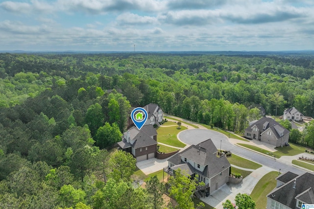 birds eye view of property with a view of trees