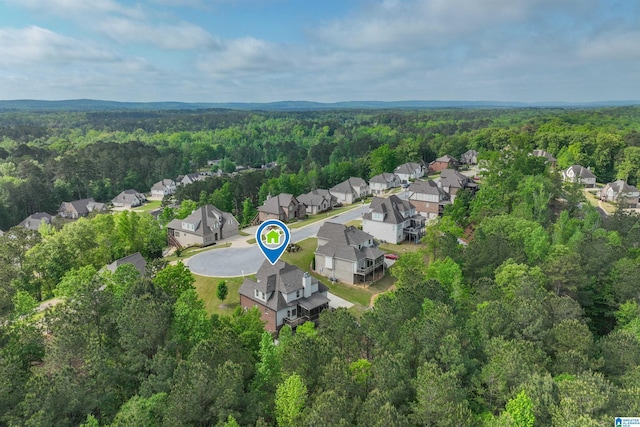 drone / aerial view featuring a view of trees and a residential view